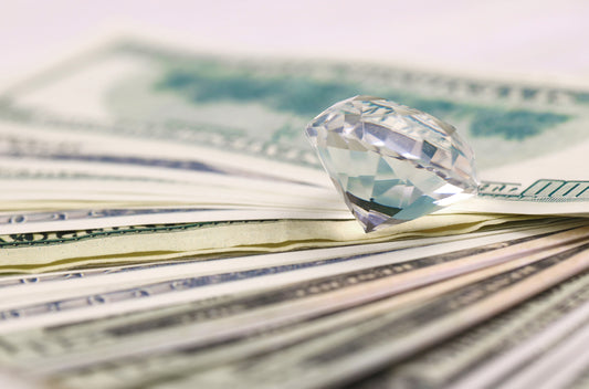 US money bills with large diamond close up