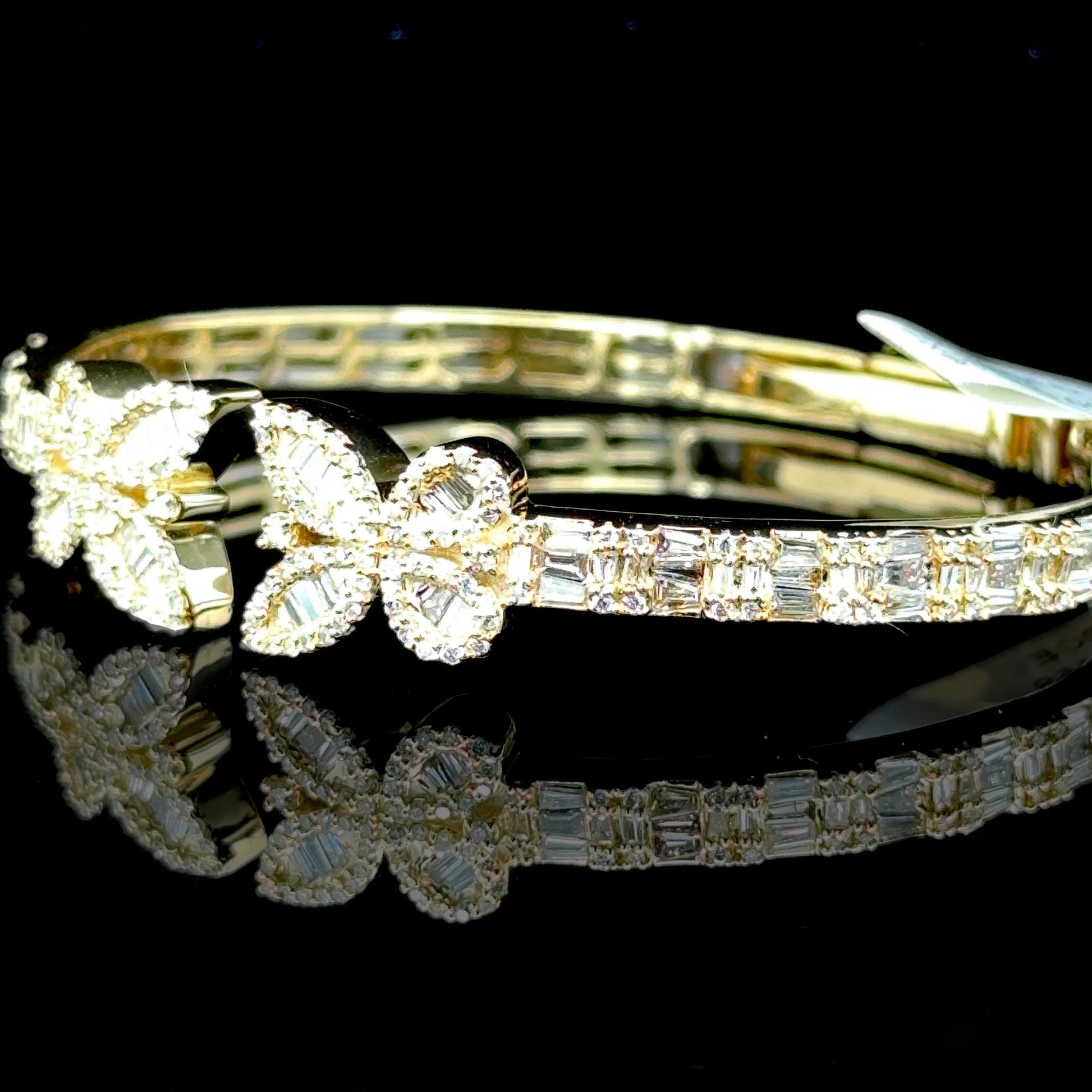 10K yellow gold bangle with a butterfly design and diamonds