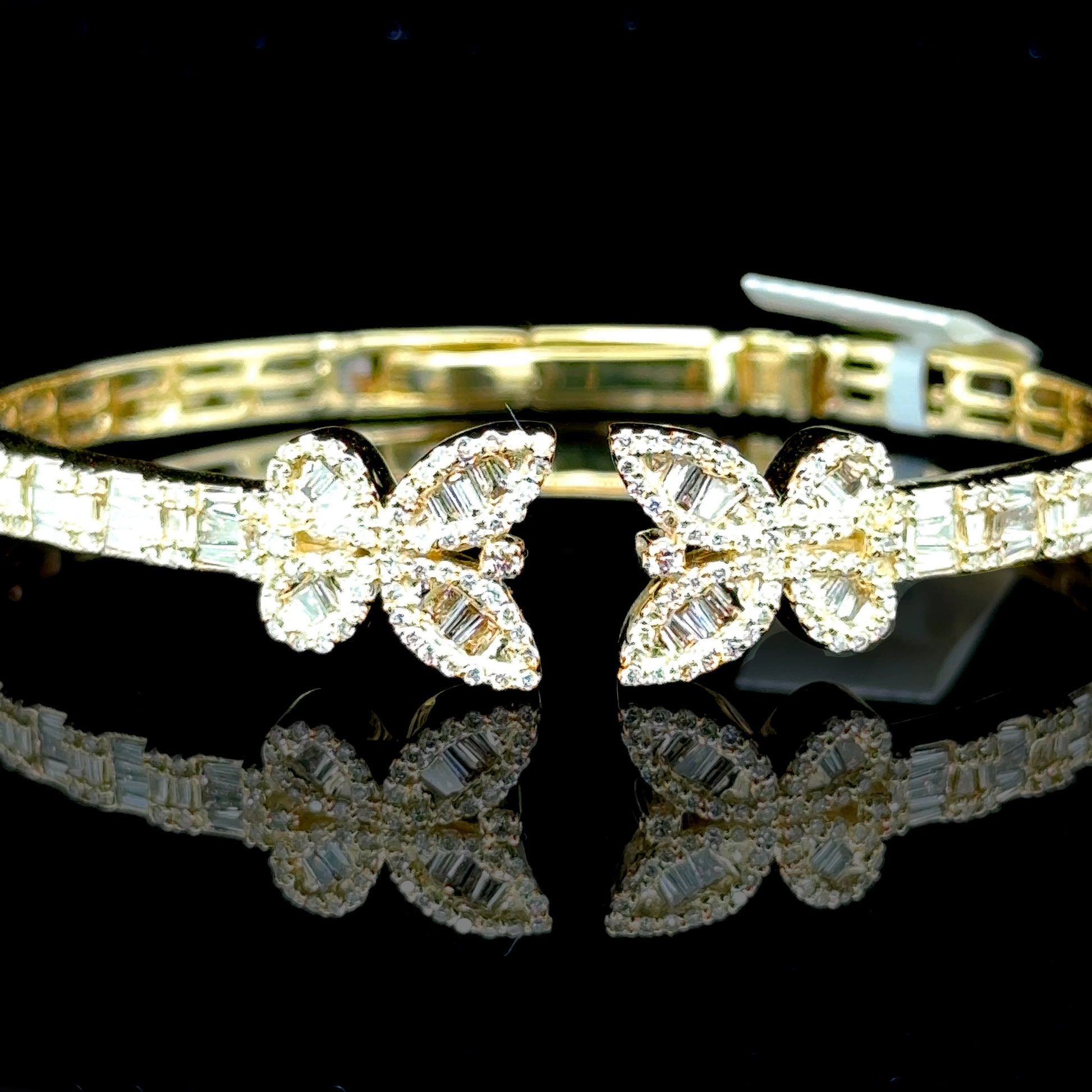 Yellow gold butterfly bangle with sparkling diamonds