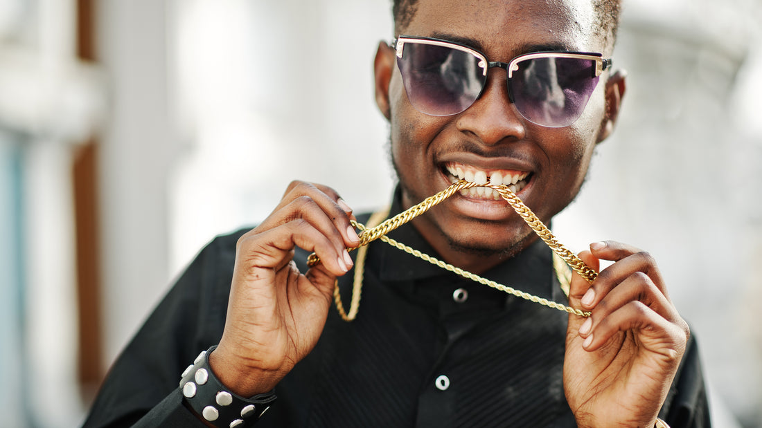 African American man with sunglasses wearing a gold chain
