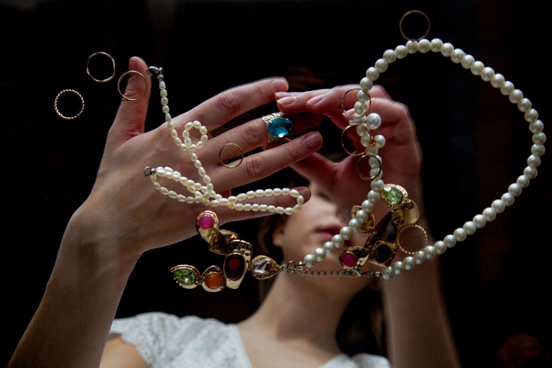 A woman trying investment jewelry like diamond engagement ring and gold necklaces