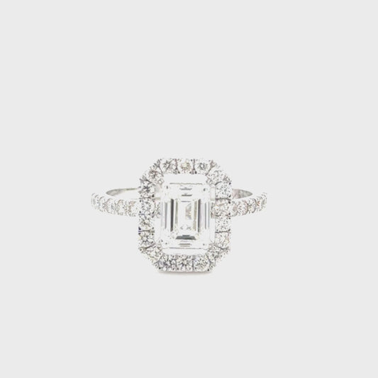14K white gold engagement ring featuring a 1.00 carat emerald cut diamond with VS1 clarity and H color, accented by 0.55 carats of diamonds.
