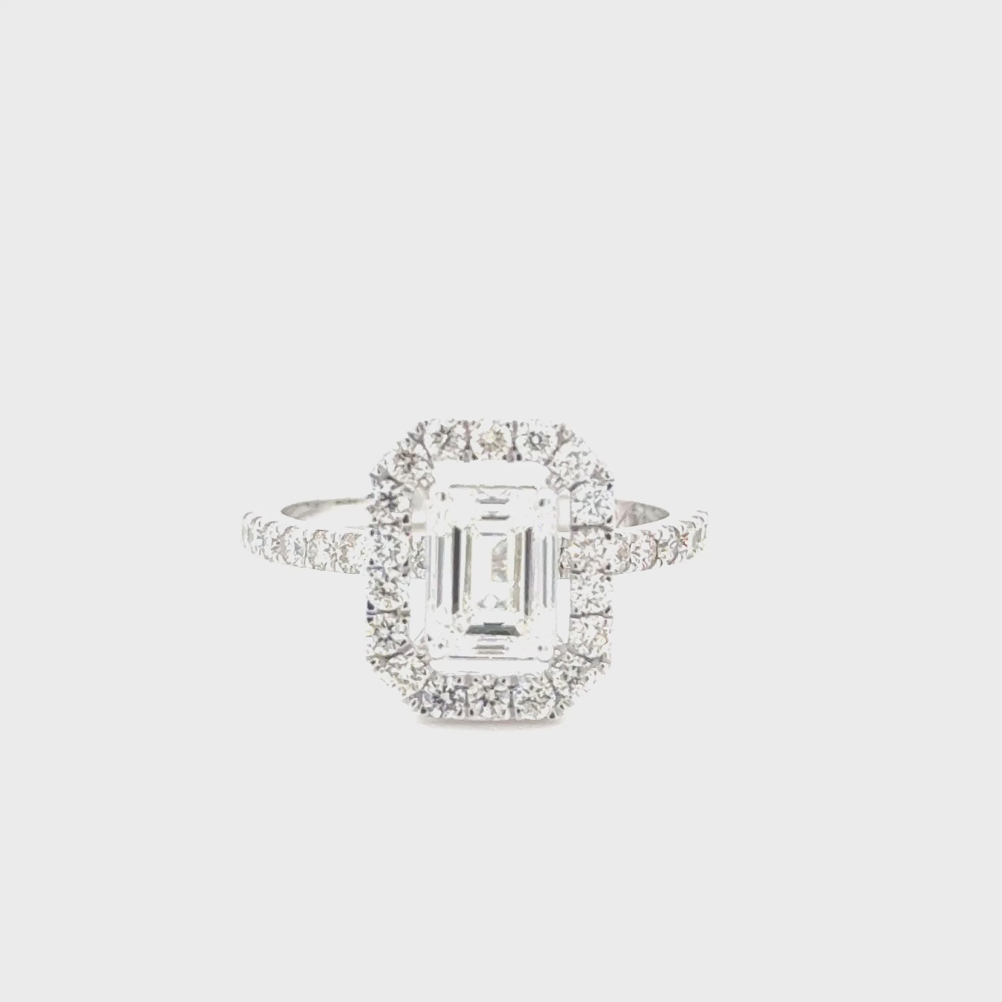 14K white gold engagement ring featuring a 1.00 carat emerald cut diamond with VS1 clarity and H color, accented by 0.55 carats of diamonds.