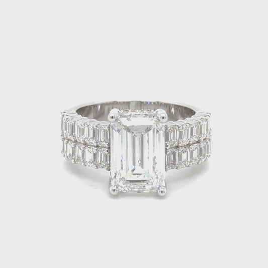14K white gold engagement ring featuring a 5 carat emerald cut lab grown diamond with VS1 clarity and E color, accented by 2.25 carats of lab grown diamonds.